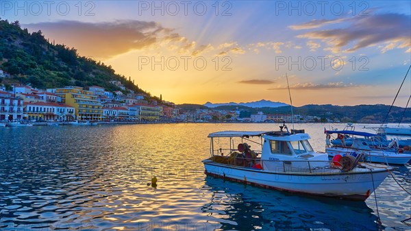 Harbour view at sunset with boats and glowing water reflections, Gythio, Mani, Peloponnese, Greece,
