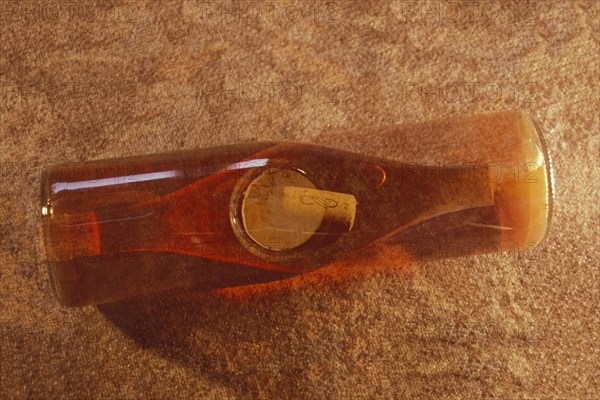 Multiple exposure of a rose wine bottle with wine cork, wine bottle, rose wine, full, view from