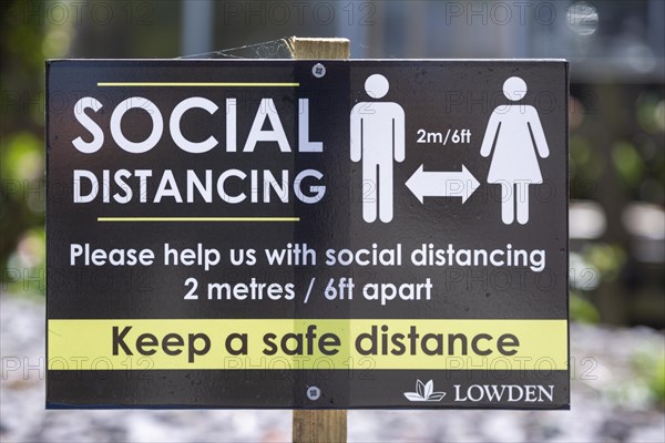 Social Distancing 2 metres apart information notice sign in Lowden garden centre shop, Wiltshire,