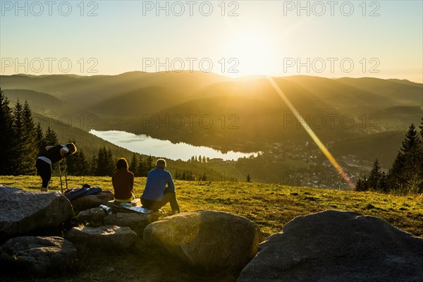 Hiking group, view from Hochfirst to Titisee and Feldberg, sunset, near Neustadt, Black Forest,