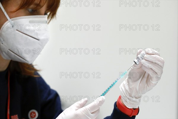 Drawing up a syringe with the Biontech Pfizer active ingredient Comirnaty against Covid19 in a