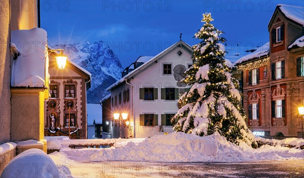 Snow-covered Christmas tree on the historic Ludwigstrasse in the Partenkirchen district with