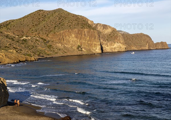 Man and woman holding hands walking on beach, Isleta del Moro, Cabo de Gata natural park, Almeria,