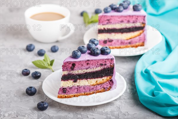Homemade cake with souffle cream and blueberry jam with cup of coffee and fresh blueberries on a