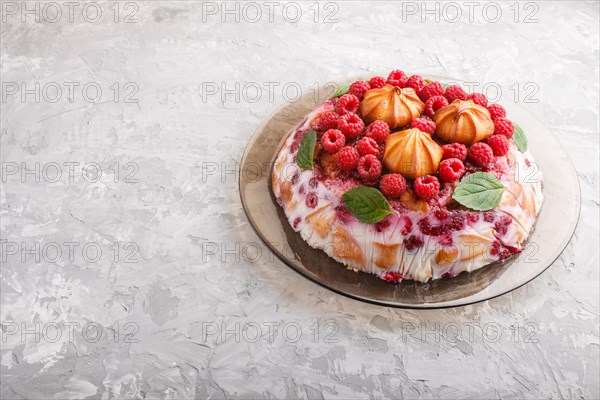 Homemade jelly cake with milk, cookies and raspberry on a gray concrete background. side view, copy