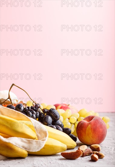 Fruits in reusable cotton textile white bag. Zero waste shopping, storage and recycling concept,