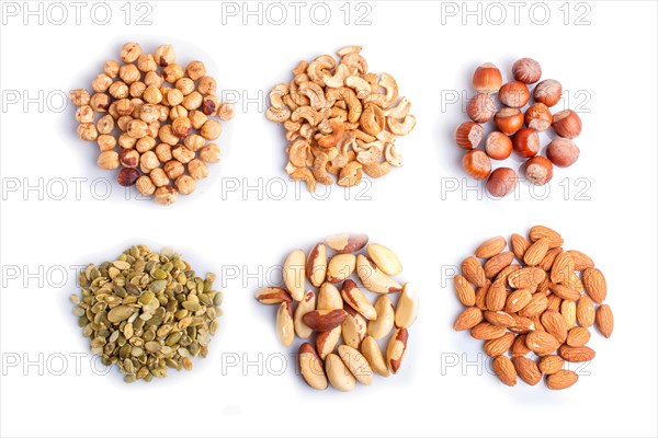Piles of various nuts and seeds isolated on white background. hazelnut, brazil nut, almond, pumpkin