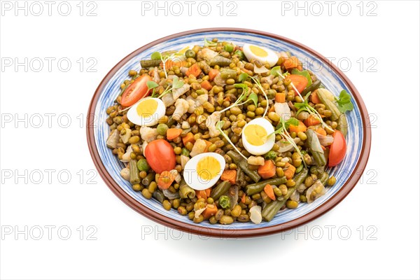 Mung bean porridge with quail eggs, tomatoes and microgreen sprouts isolated on a white background.