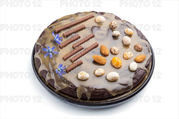 Homemade chocolate brownie cake with caramel cream and almonds isolated on a white background. Side