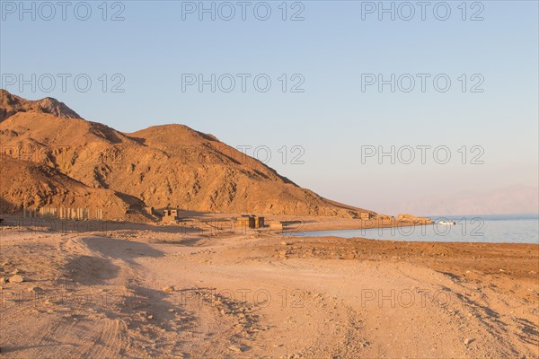 The coastline of the Red Sea and the mountains in the background, sunset. Egypt, the Sinai