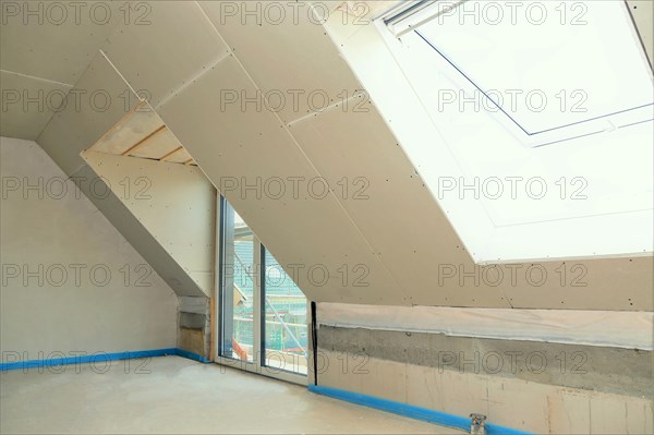 Attic conversion, loft conversion. You can see the pitched roof with door and skylight panelled