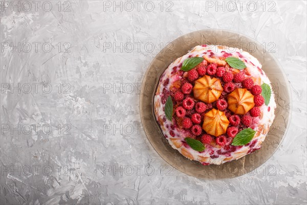 Homemade jelly cake with milk, cookies and raspberry on a gray concrete background. top view. flat