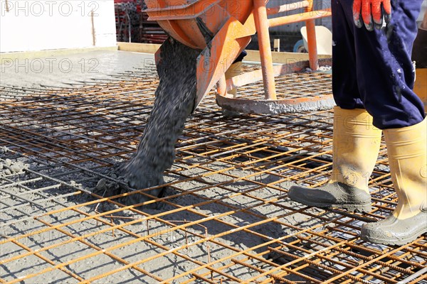 Concreting a floor slab with ready-mixed concrete on the construction site of a residential
