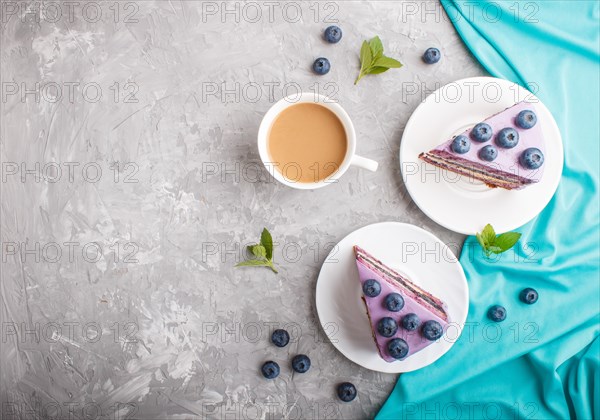 Homemade cake with souffle cream and blueberry jam with cup of coffee and fresh blueberries on a