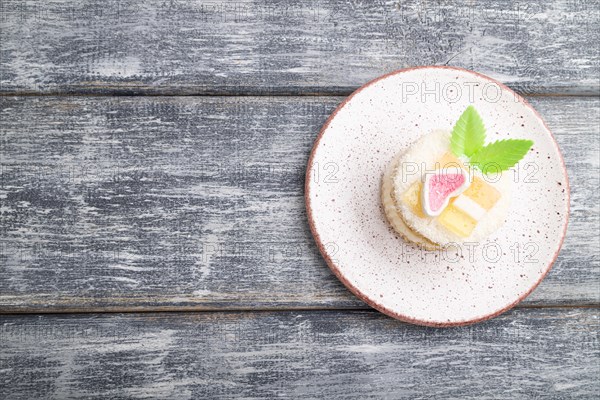 Decorated cake with milk and coconut cream on a gray wooden background. top view, flat lay, copy