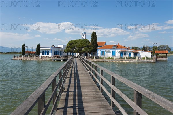 Monastery complex with church at the end of a bridge over calm water, Monastery of St Nicholas,