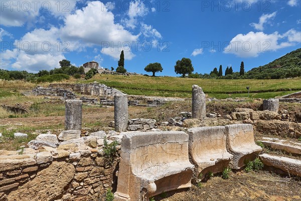Remains of an ancient ruins site with column fragments in a green landscape, Archaeological site,