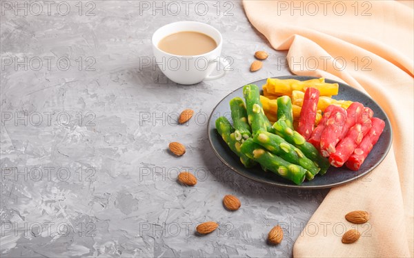 Set of various traditional turkish delight (rahat lokum) in blue ceramic plate with cup of coffee