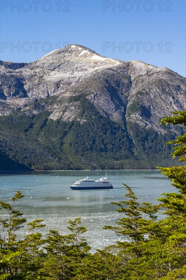 Cruise ship Stella Australis anchored between ice floes in Pia Bay in front of the Pia Glacier,
