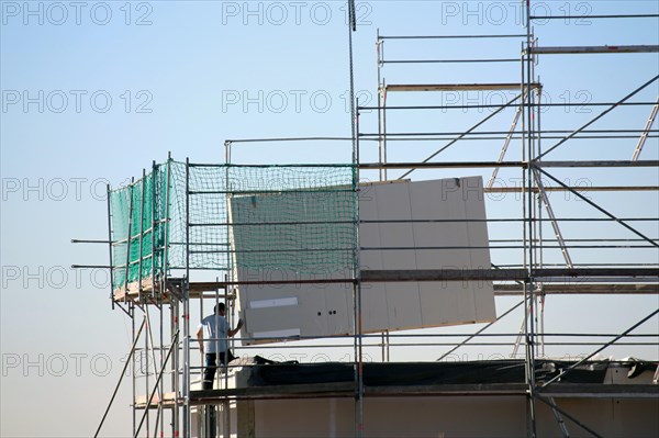 Prefabricated house under construction, the exterior walls are being delivered (Bad Duerkheim,