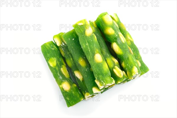 Green traditional turkish delight (rahat lokum) with peanuts isolated on white background. top