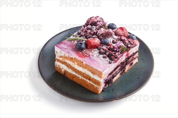 Berry cake with milk cream and blueberry jam on blue ceramic plate isolated on white background.