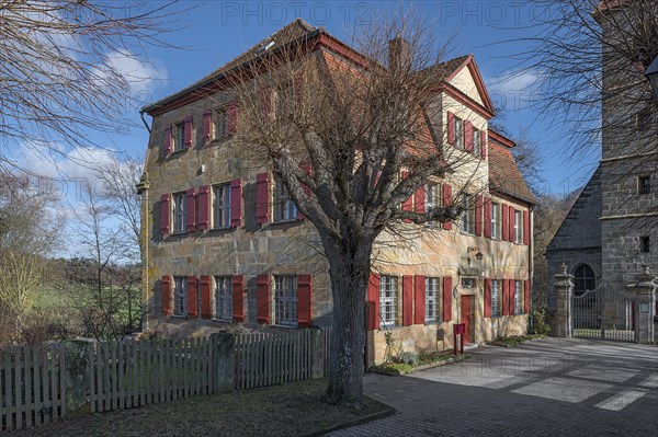 Historic vicarage of St Egidienkirche from 1734, in front of it a trimmed summer lime tree (Tilia