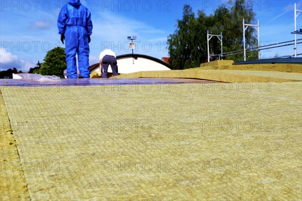 Employees of Uwe Adrian Bauspenglerei GmbH from Worms insulate the roof of a multi-purpose hall in