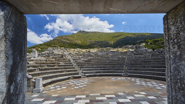 View through an arched entrance to the ruins of an ancient theatre, sanctuary of Asclepius,