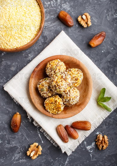 Energy ball cakes with dried apricots, sesame, cornflakes, linen, walnuts and dates with green mint