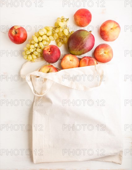 Fruits in reusable cotton textile white bag. Zero waste shopping, storage and recycling concept,