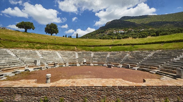 Ruins of an ancient theatre with seating steps standing out against the blue sky, Ancient theatre,