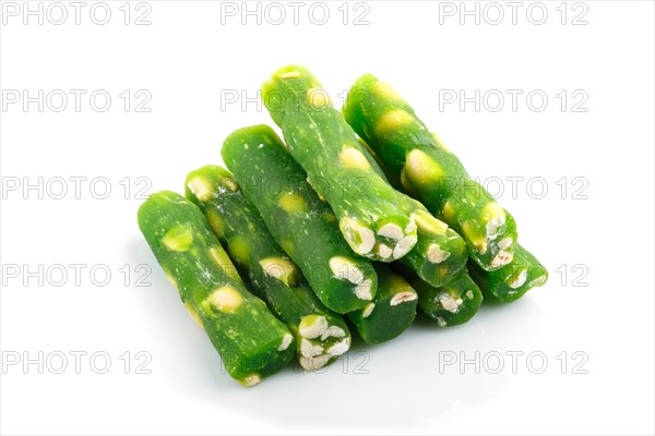 Green traditional turkish delight (rahat lokum) with peanuts isolated on white background. side