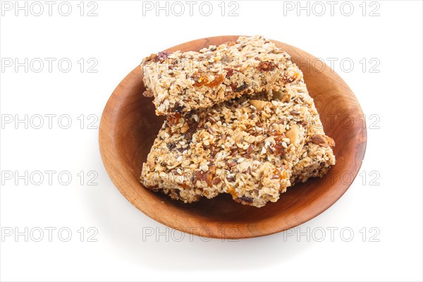 Homemade granola from oat flakes, dates, dried apricots, raisins, nuts in brown wooden plate