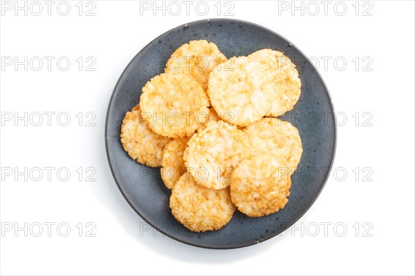 Traditional japanese rice chips cookies with honey and soy sauce on a blue ceramic plate isolated