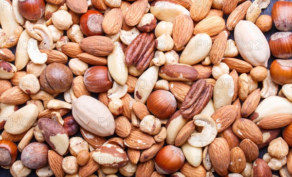 Background and texture made from different kinds of nuts. hazelnut, brazil nut, almond, pumpkin