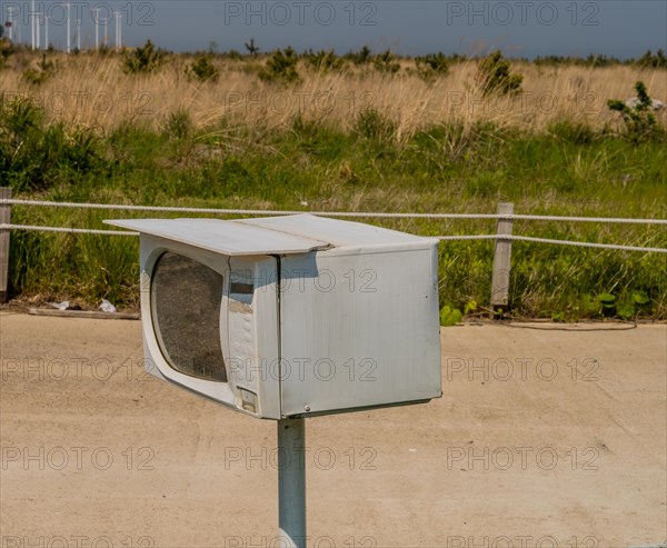 Small microwave oven on metal pole used as mailbox in South Korea