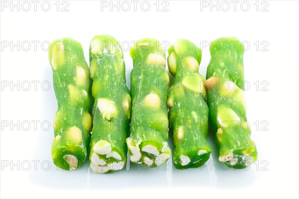 Green traditional turkish delight (rahat lokum) with peanuts isolated on white background. side