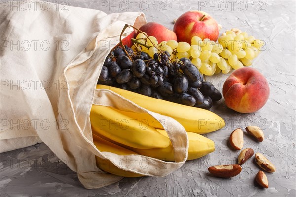 Fruits in reusable cotton textile white bag. Zero waste shopping, storage and recycling concept,