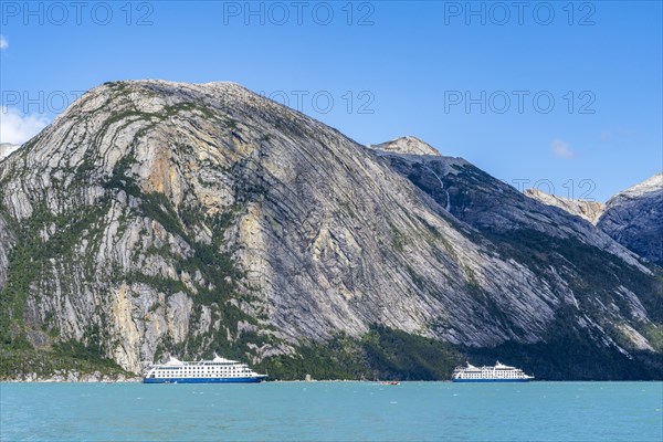Cruise ship Stella Australis and sister ship Ventus Australis anchored between ice floes in Pia Bay
