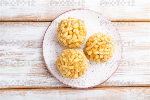 Traditional Tatar candy chak-chak made of dough and honey on a white wooden background. top view,