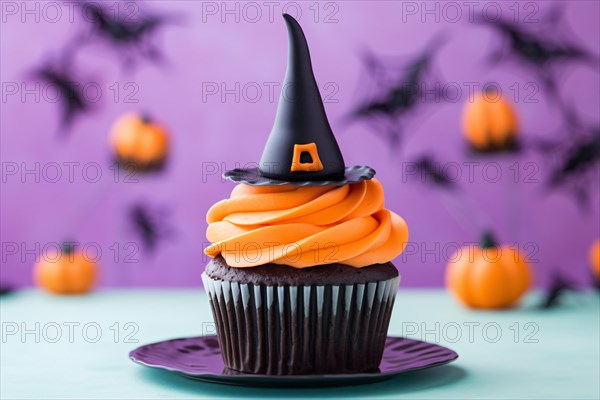 Halloween cupcake with orange frosting and black witch hat topping. KI generiert, generiert AI