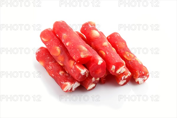 Red traditional turkish delight (rahat lokum) with peanuts isolated on white background. side view,