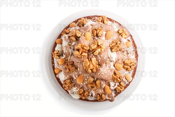 Homemade cake with milk cream, cocoa, almond, hazelnut isolated on white background. Top view, flat