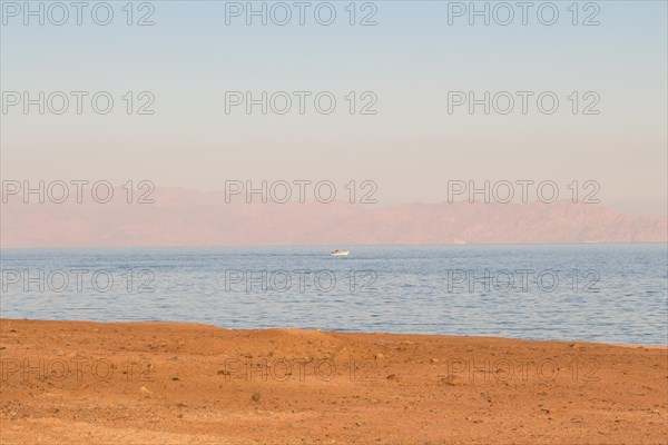 The coastline of the Red Sea and the mountains in the background, sunset. Egypt, the Sinai