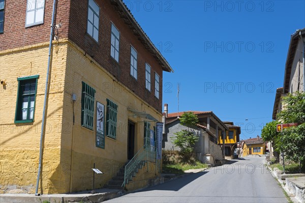 Charming cobbled street with rustic, colourful houses in an old town, Koukoulospito, house with