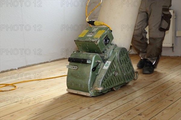 A parquet floor is sanded and oiled