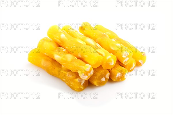 Yellow traditional turkish delight (rahat lokum) with peanuts isolated on white background. side