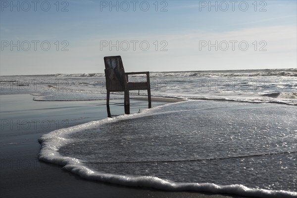 Upholstered chair washed up on the North Sea shore, flotsam, Oksbol, Region Syddanmark, Denmark,