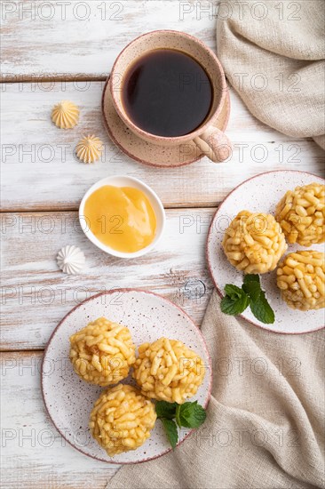 Traditional Tatar candy chak-chak made of dough and honey with cup of coffee on a white wooden